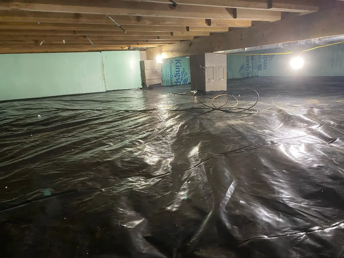 Clean crawl space encapsulation with vapor barrier after waterproofing work