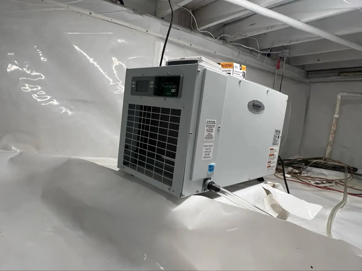 Crawl space dehumidifier installed after moisture-control work
